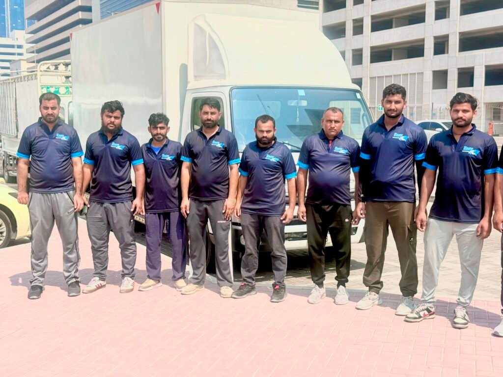 Professional movers packing boxes and loading a moving truck in Dubai